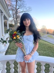 Woman in blue dress and long black hair. 
