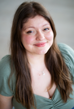 Women with green top and long brown hair. 
