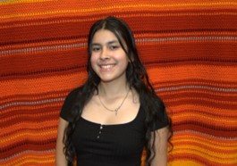 Woman with black top and long black hair. 