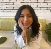 Woman with white top and long black hair. 