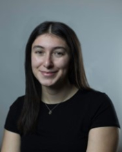 Girl with dark brown hair wearing a black t-shirt