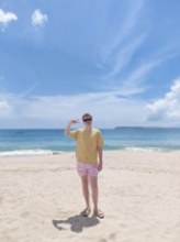 Appalachian alumna Connor Montanya ’24 ’25, from Waxhaw, North Carolina, is a Fulbright English Teaching Assistantship recipient for the 2025–26 cycle. He has begun his teaching assignment in Penghu, Taiwan. Man on beach with black sunglasses, yellow shirt, and red swim trunks.