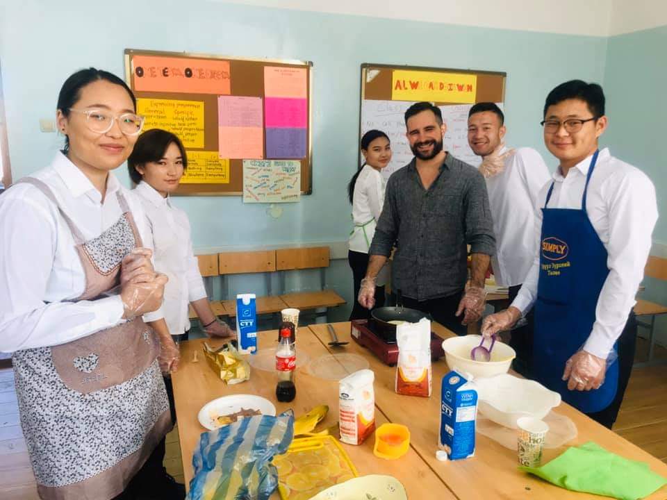 My students and I cooking banana pancakes for our international food day. USA food competed with Chinese, Korean, and Russian food. We cooked many other dishes, too